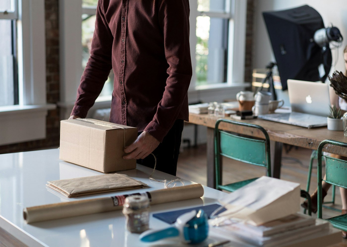 A seller packing orders at his desk